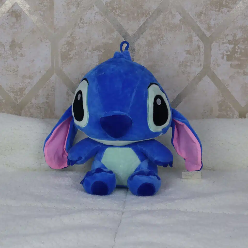 Peluche azul de 30 cm inspirado en Stitch, visto de lado